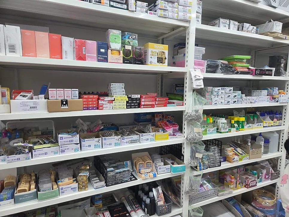 Store shelves with kitchenware and stationery together