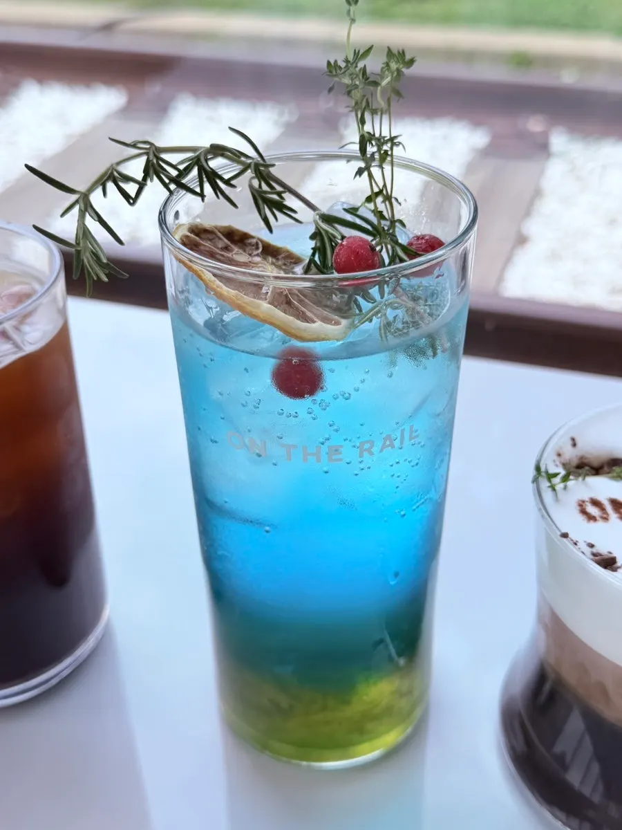 A glass of green grape ade filled with ice