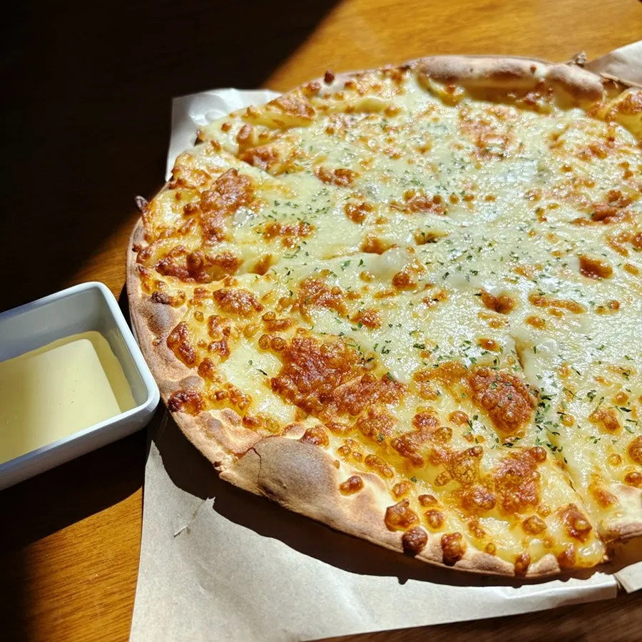 Thin-crust gorgonzola pizza piled with plenty of cheese