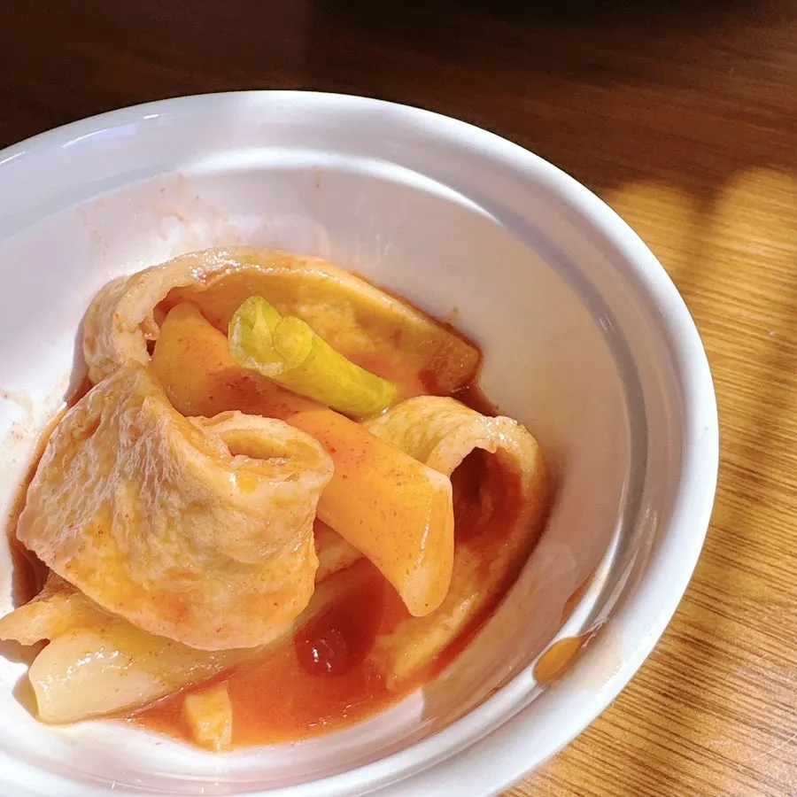 A bowl of corn soup topped with croutons