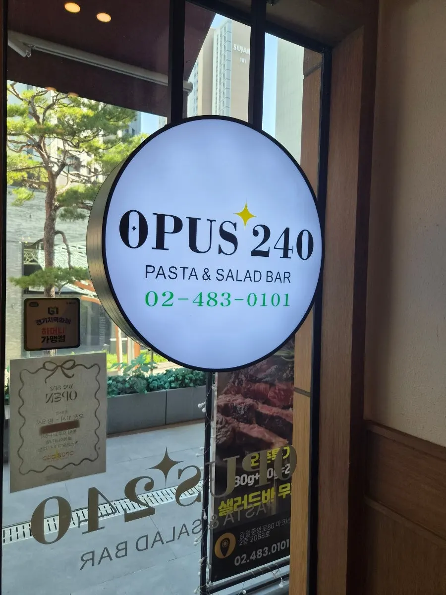Sign showing Opus240's storefront