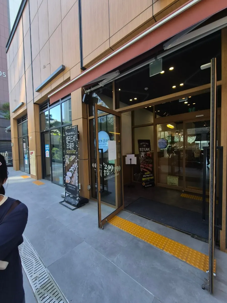 Sign showing Opus240's storefront