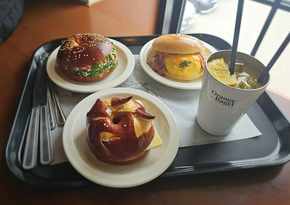 Three bagels and orange juice on the table