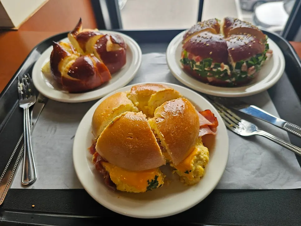 Three bagel plates and drinks spread on the table