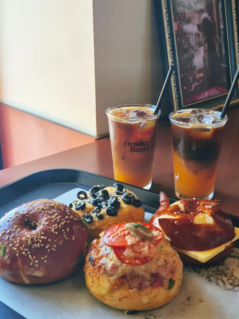 Four bagels and coffee set on a table