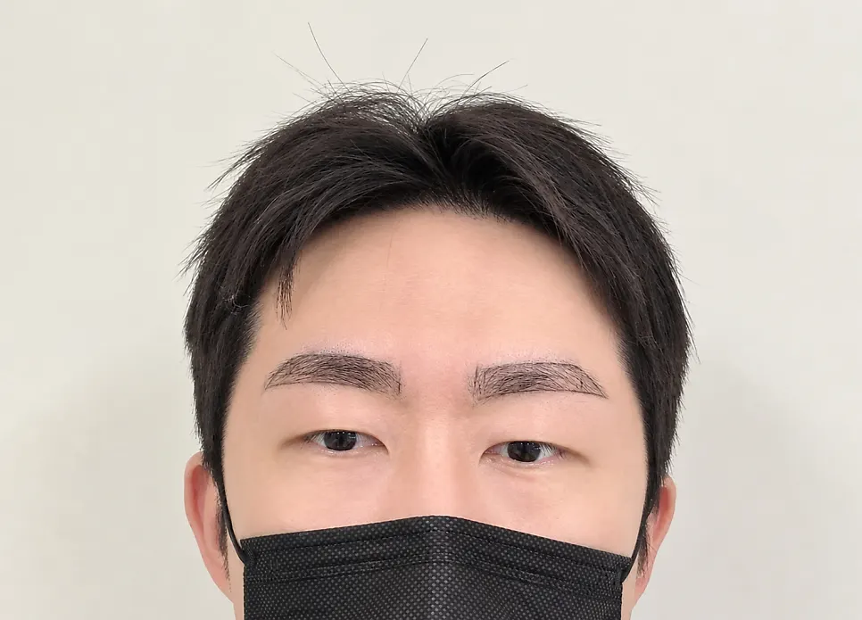 Adjusting the eyebrow design while checking the mirror