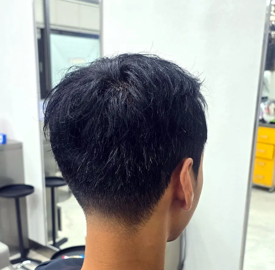 The tidied back hair connection of the drop cut