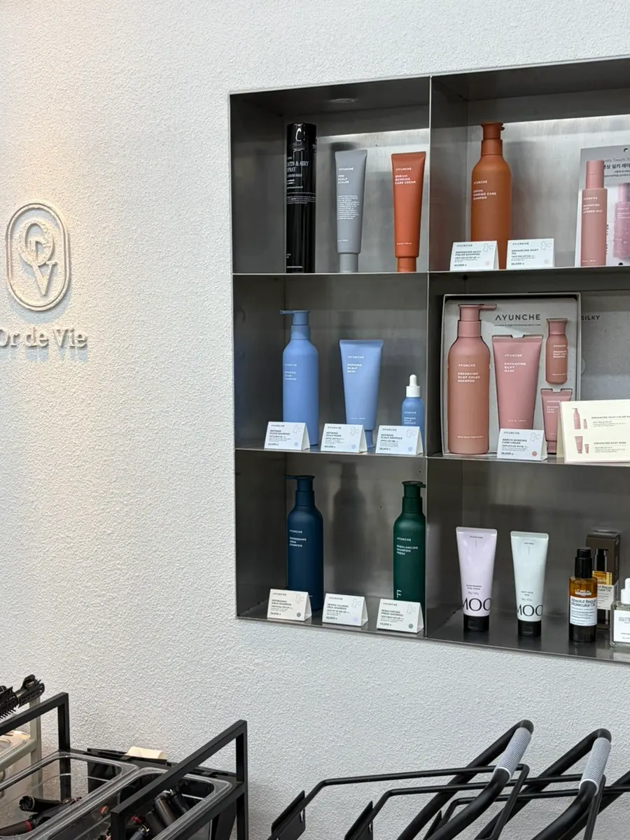Signage listing products used: Ayounche, Milbon, L'Oréal