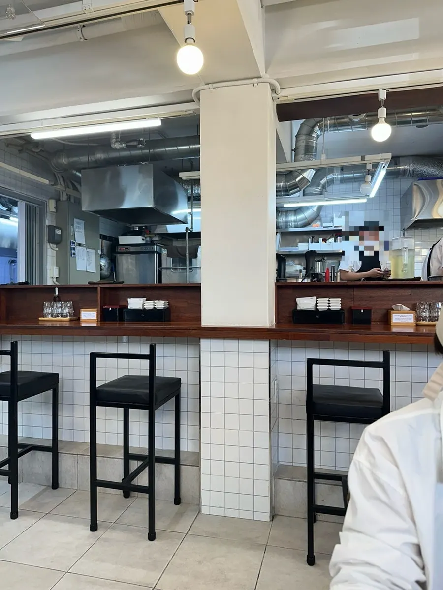 Counter seats around the kitchen with 4-person tables