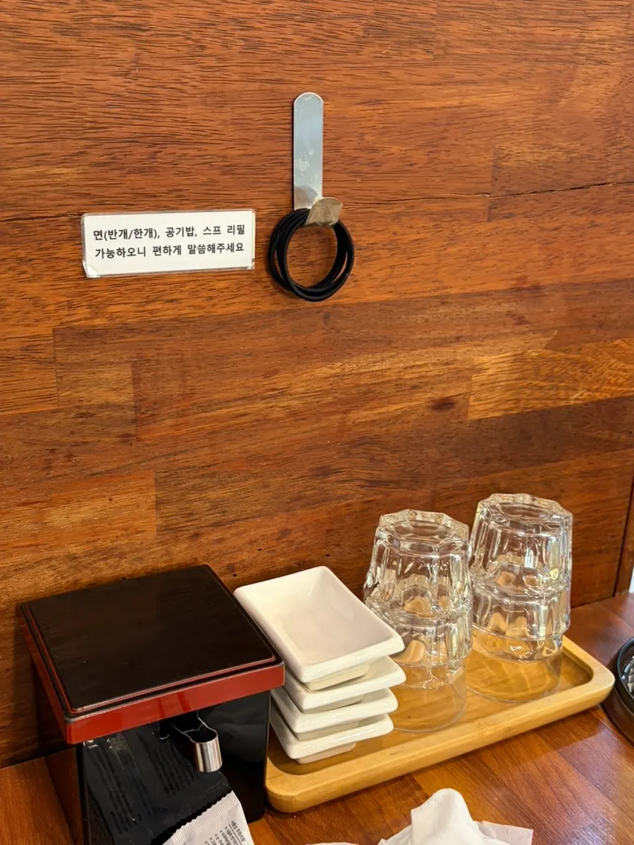 Sign explaining noodle, rice, and soup refills