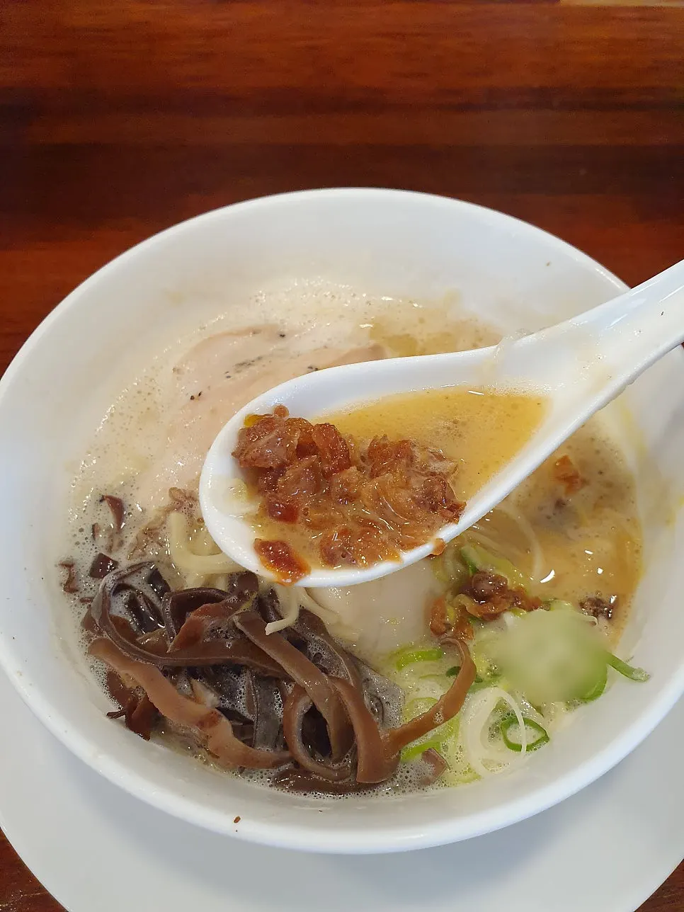 House-made ramen noodles being lifted up