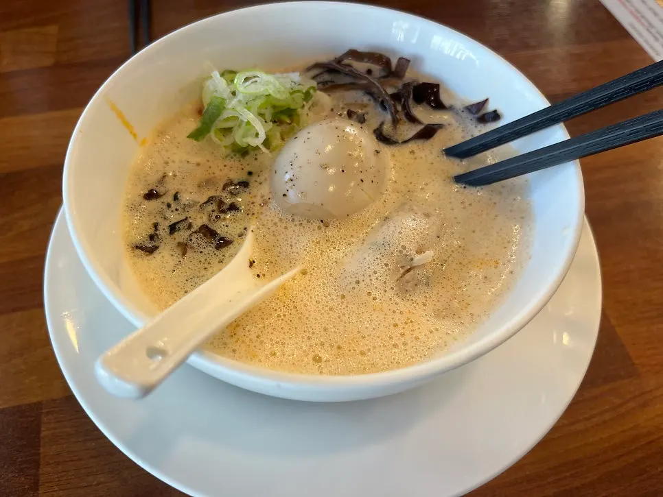 Table set with two bowls of karai paitan and tori paitan
