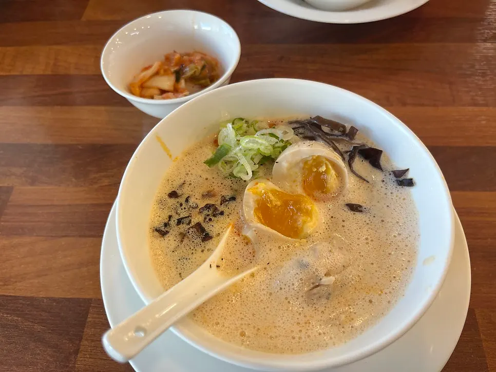 Close-up of spicy karai paitan topped with a soft-boiled egg