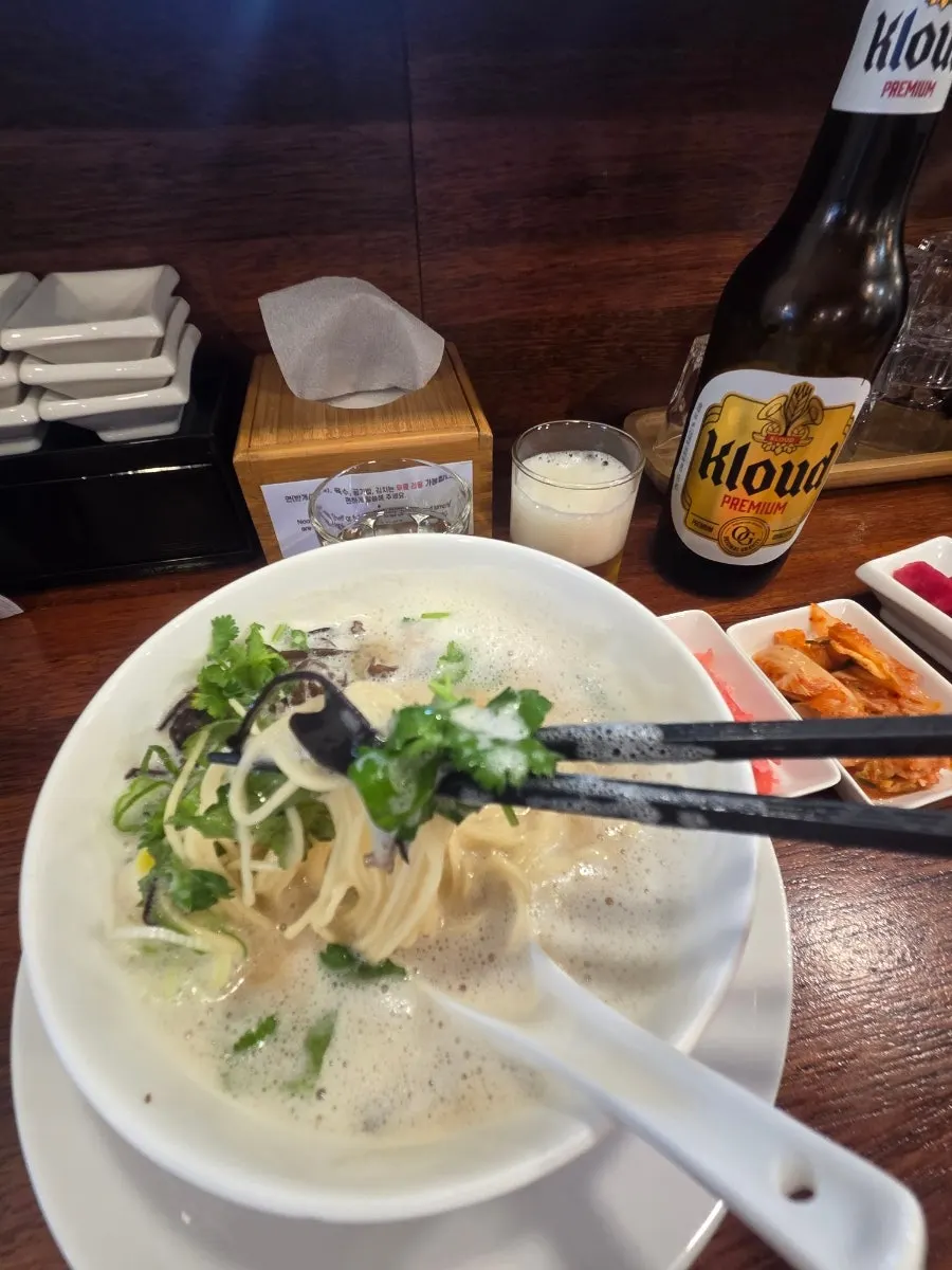 Ramen noodles lifted with chopsticks