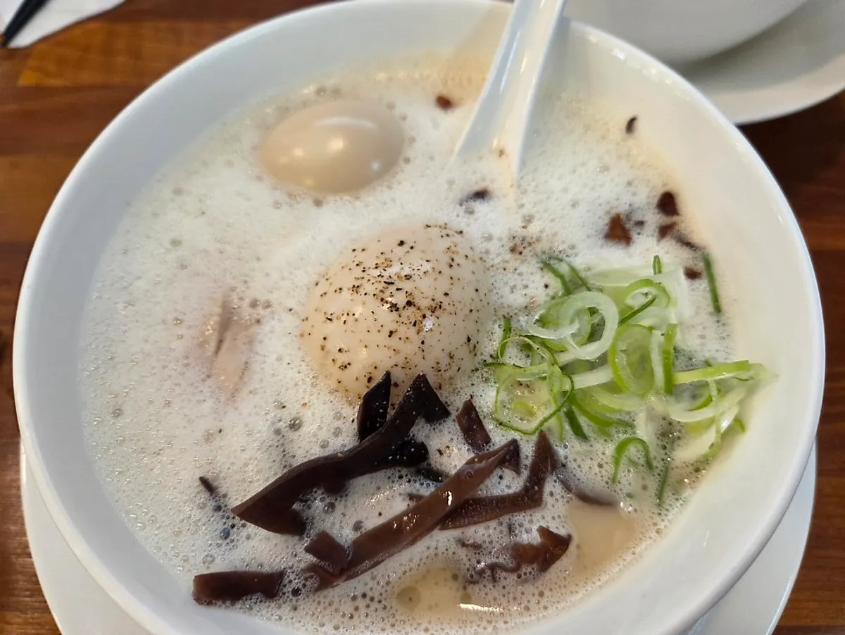 A bowl of tori paitan ramen with milky, rich broth