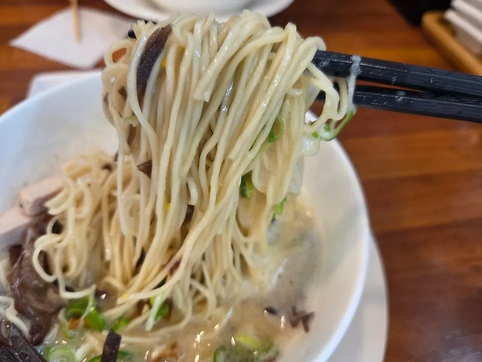 Ramen noodles lifted up with chopsticks