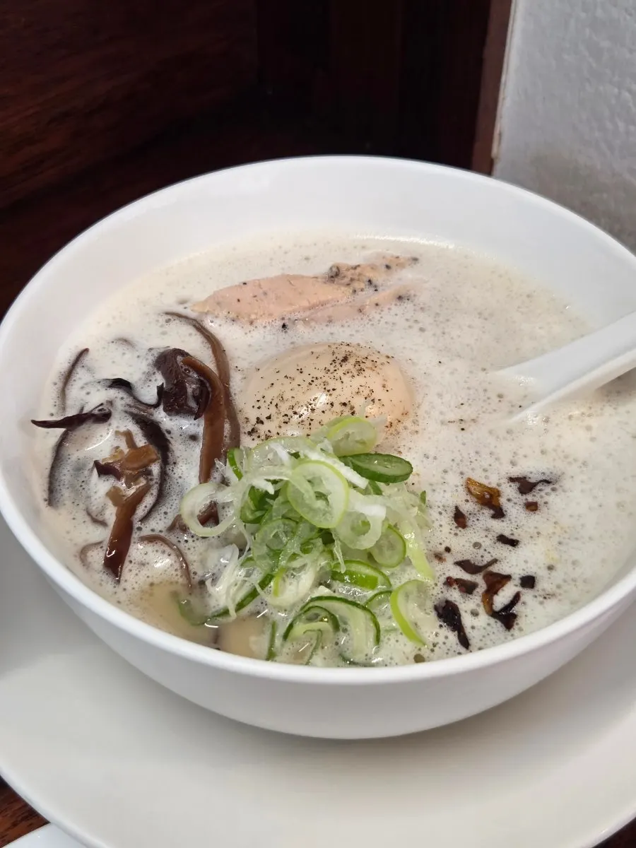 A bowl of pale, bubbling tori paitan