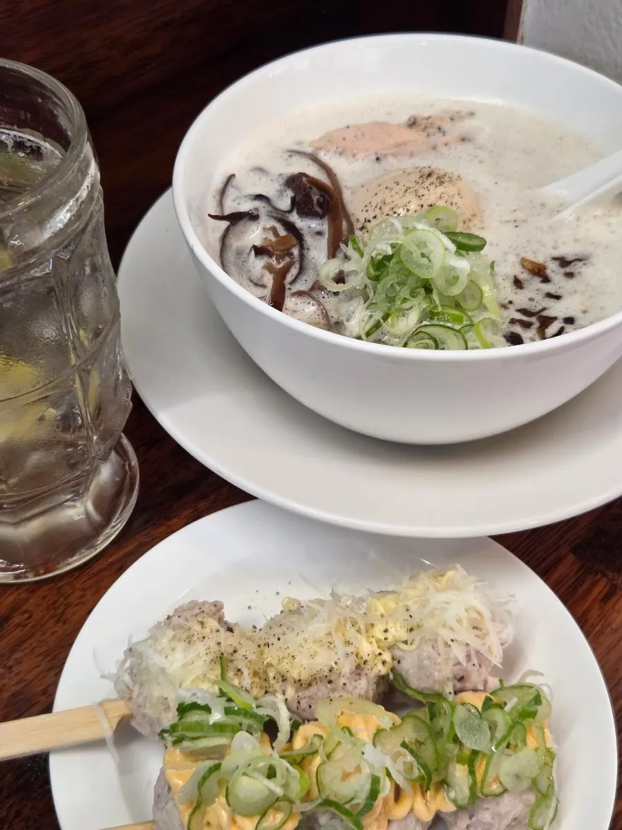 Tori paitan topped with scallions, soft-boiled egg, and chicken
