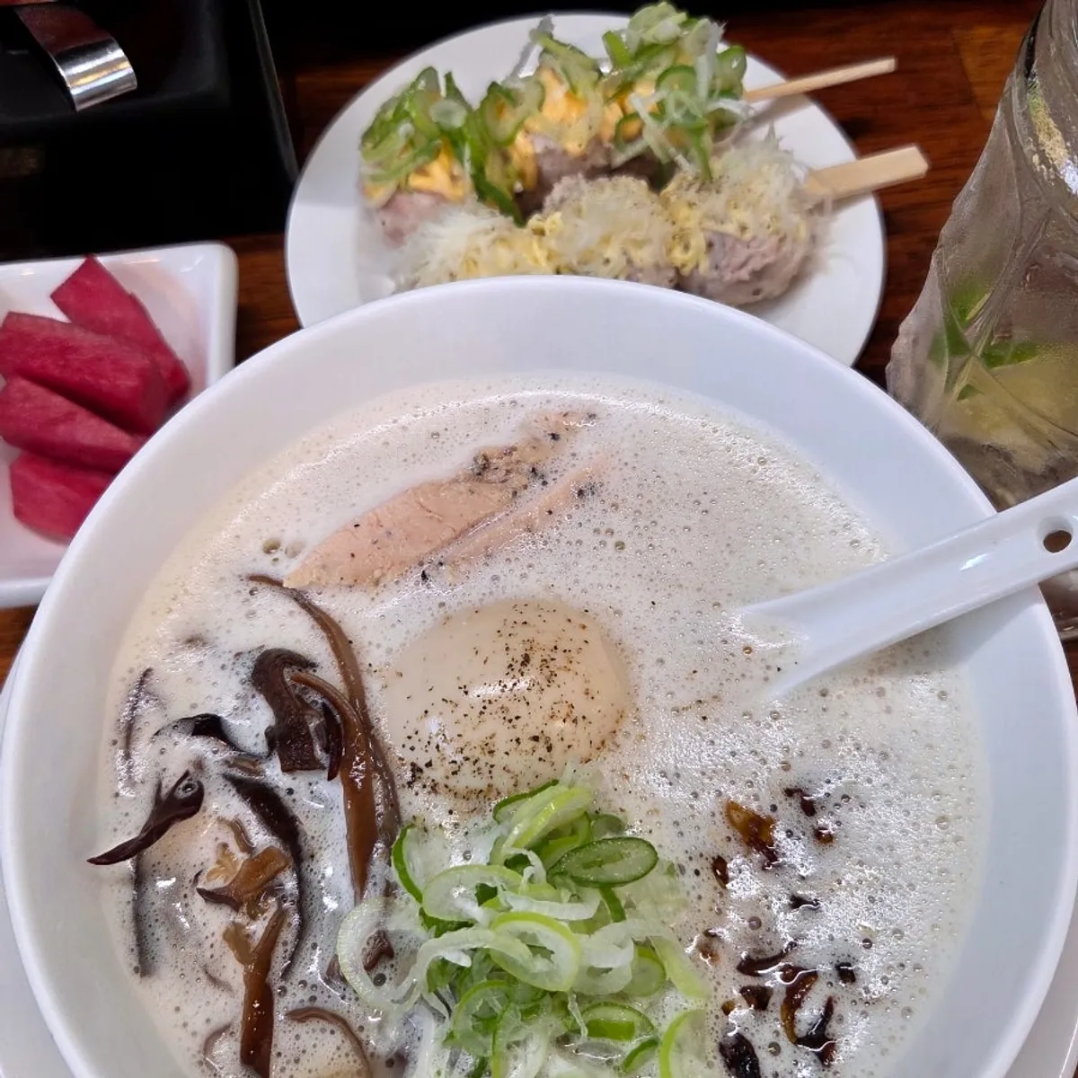 A full spread of tori paitan, tsukune, and highball
