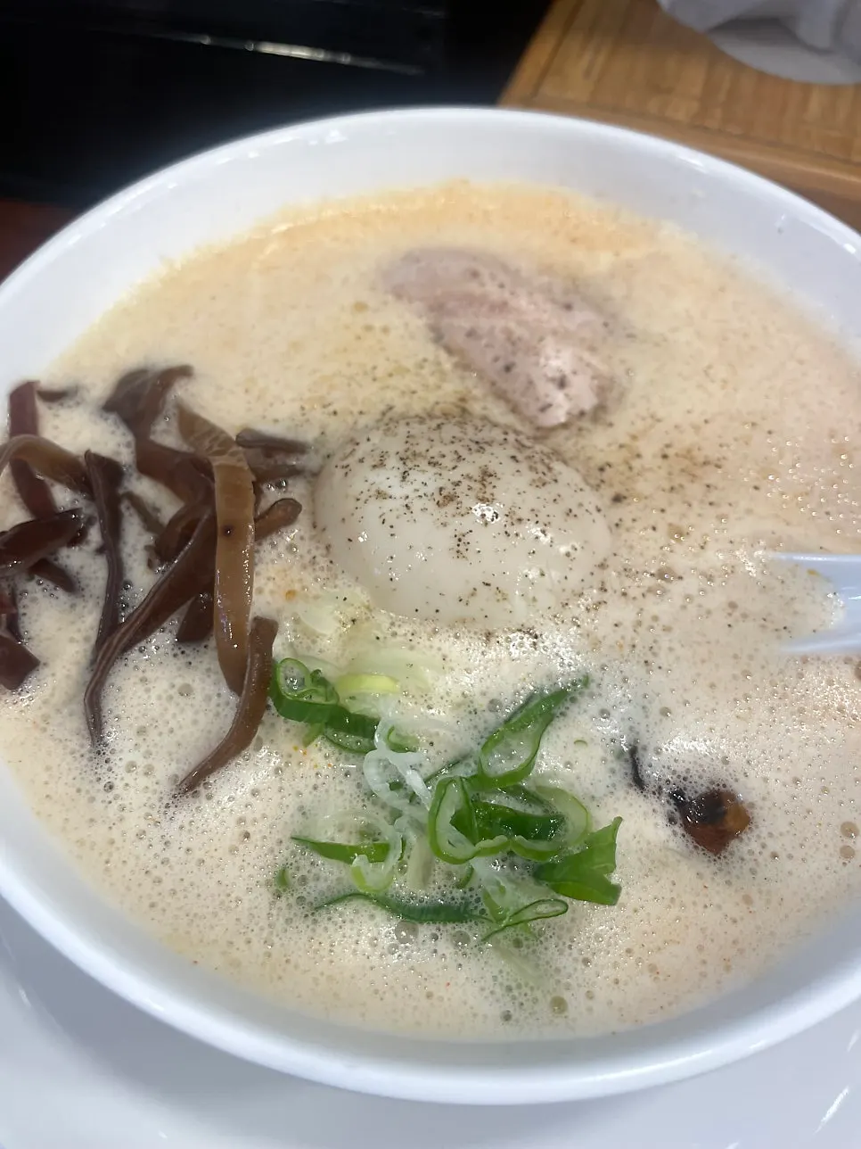 Two foam-topped paitan ramen bowls
