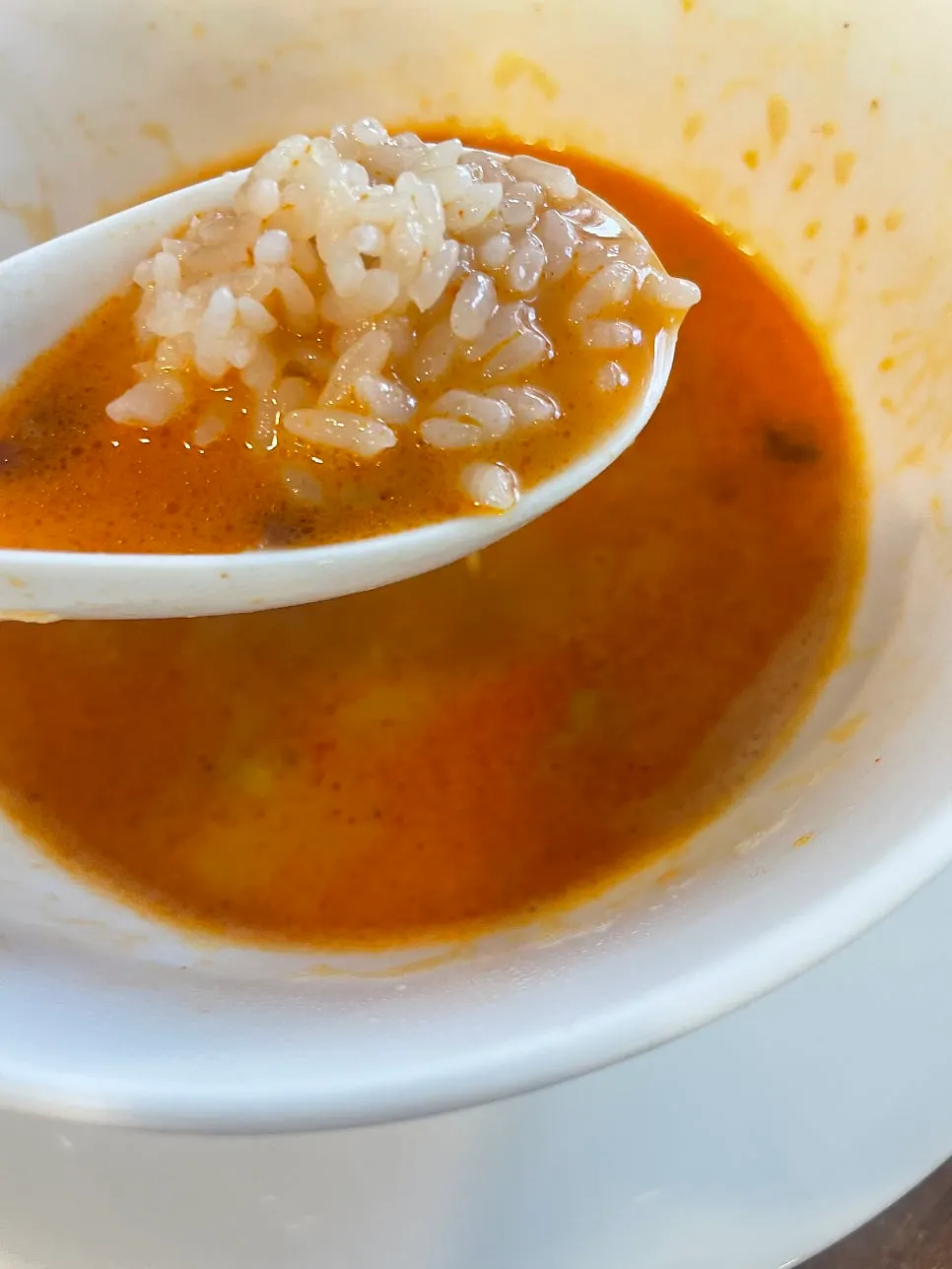 Mixing rice into the ramen broth
