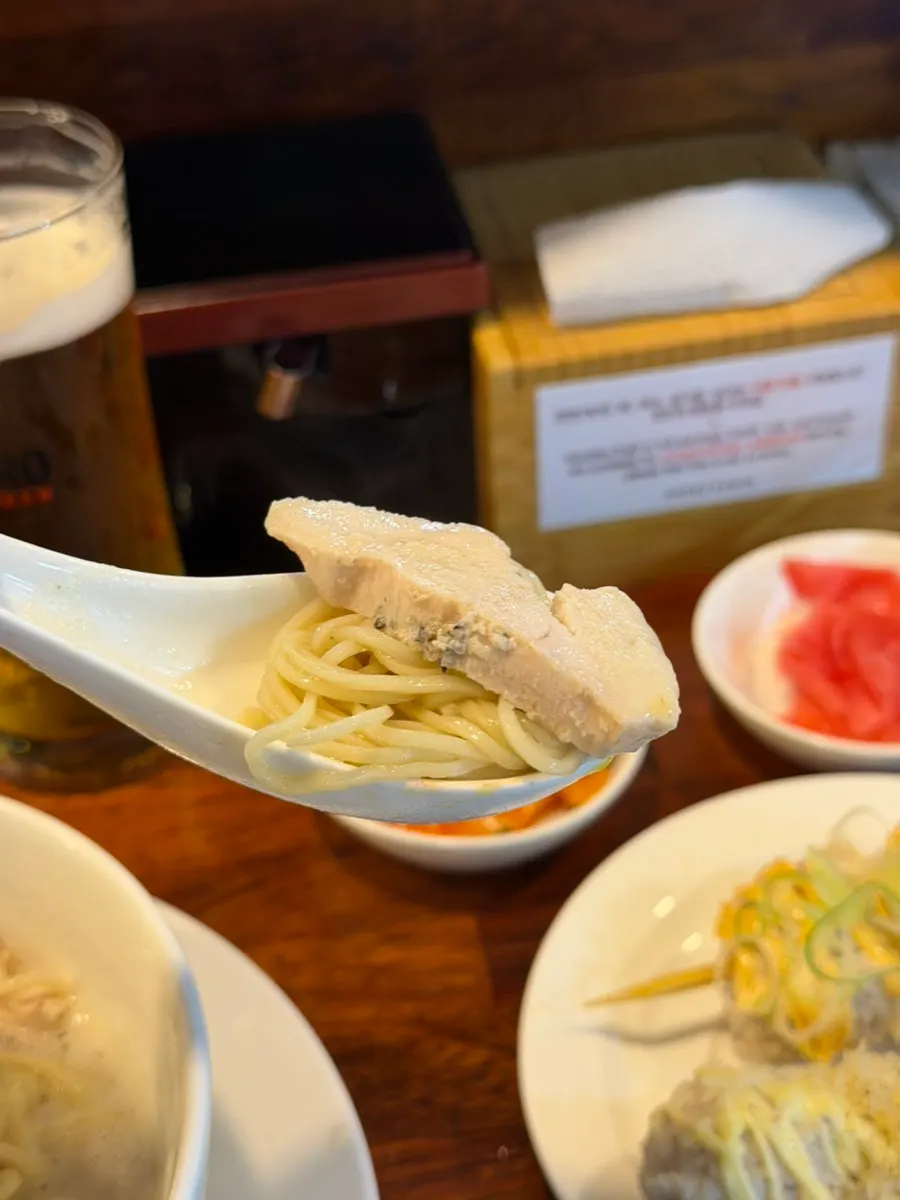 Draft beer served alongside tori paitan broth
