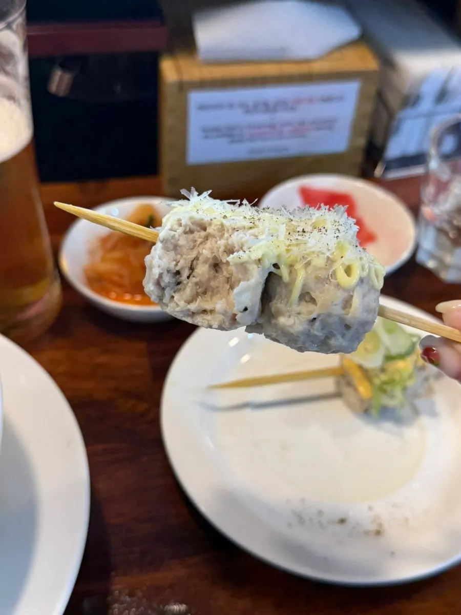 Close-up of tsukune topped with sauce