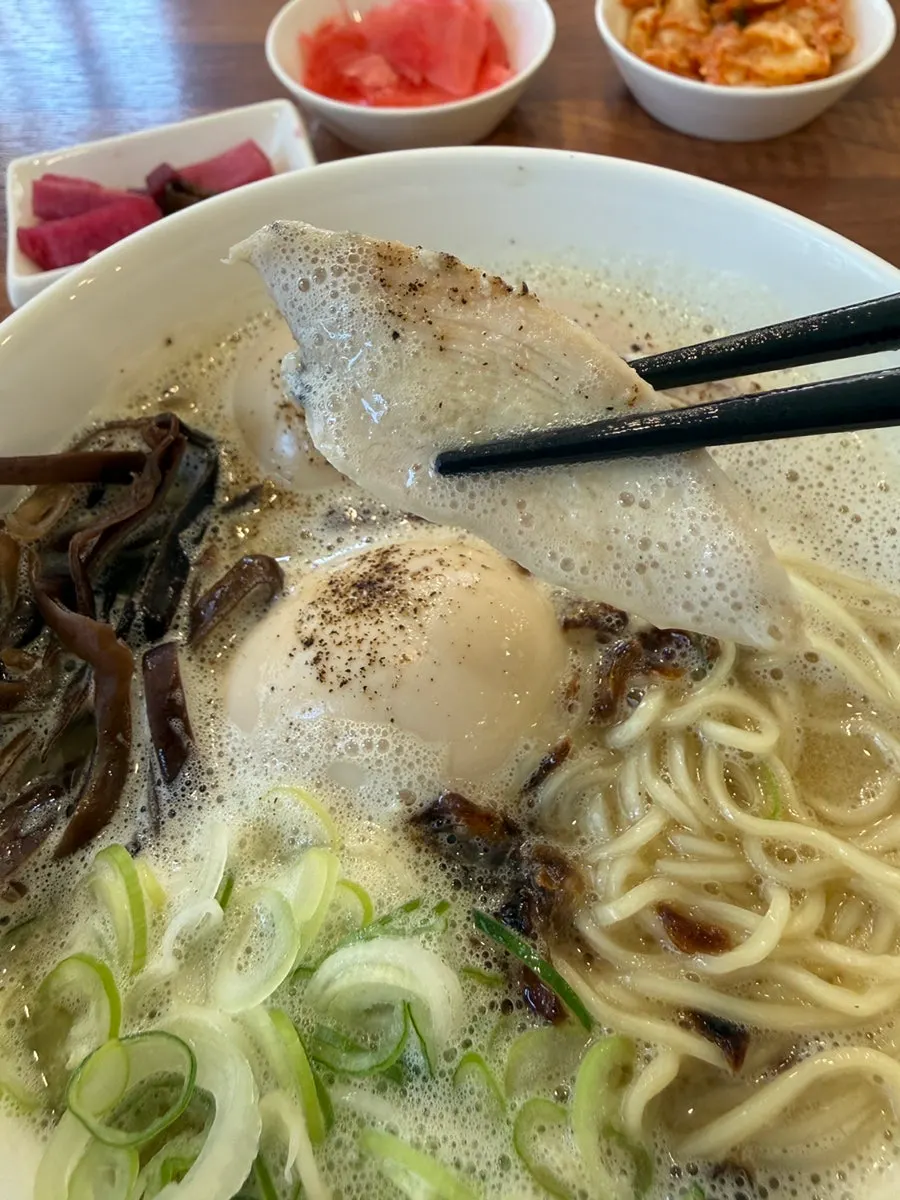 Japanese-style ramen noodles lifted with chopsticks