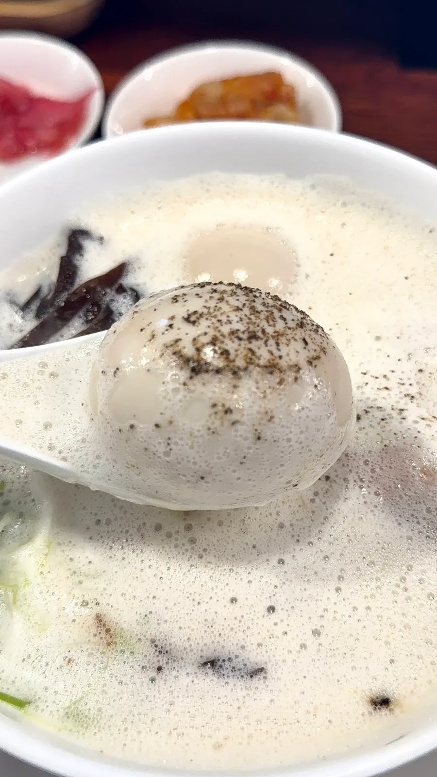 Bowl of tori paitan topped with foam