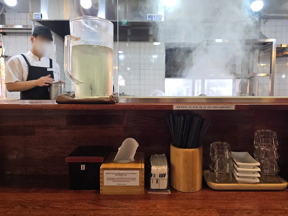 Menu board showing ramen and side dish prices