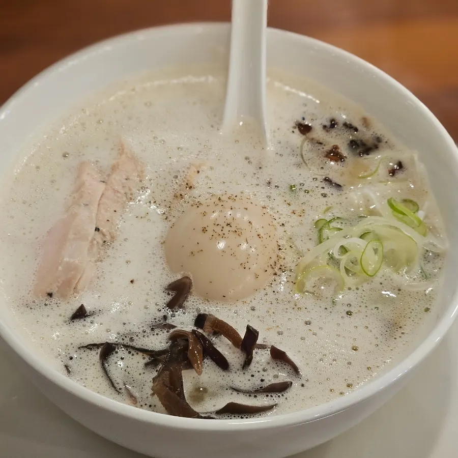 Chicken breast and soft-boiled egg on top of tori paitan