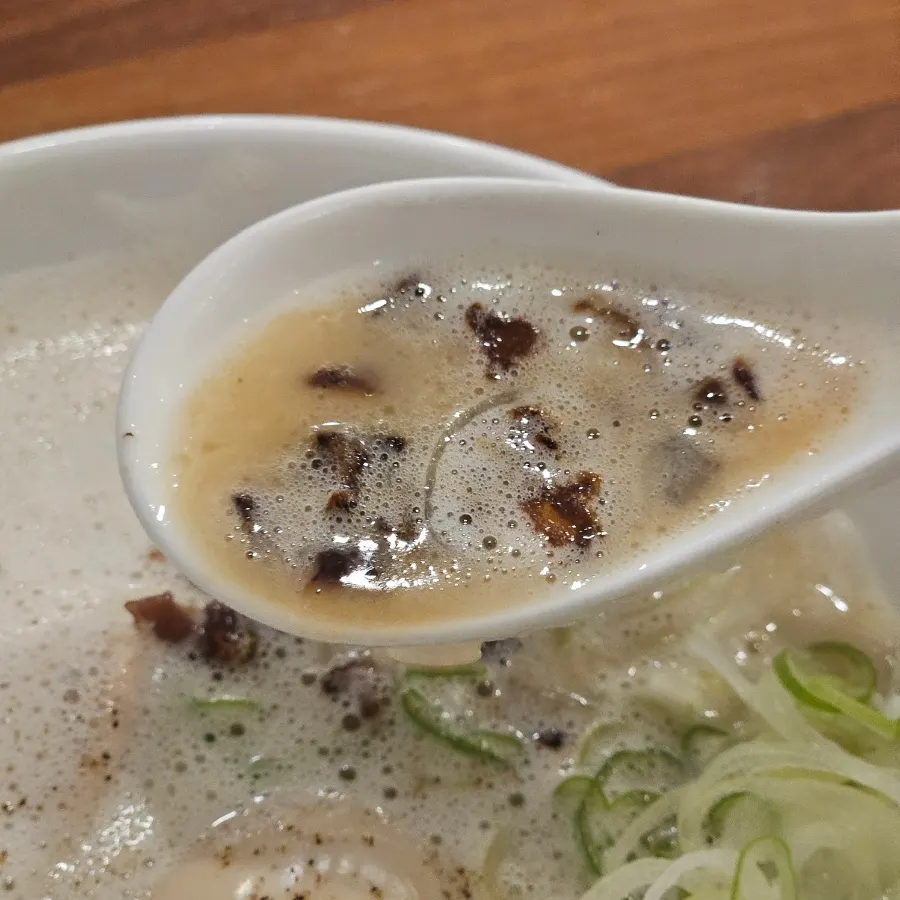 Close-up of tori paitan topped with wood ear mushroom