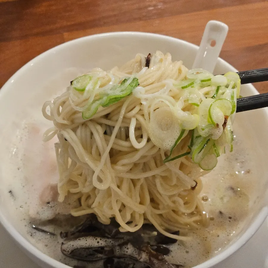 Digging into a bowl of tori paitan
