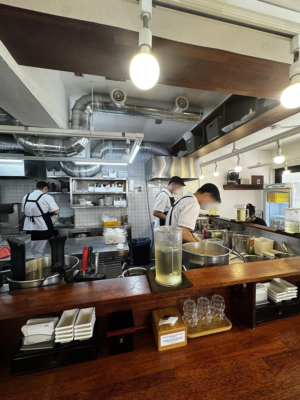 View of the open kitchen at the center of the restaurant