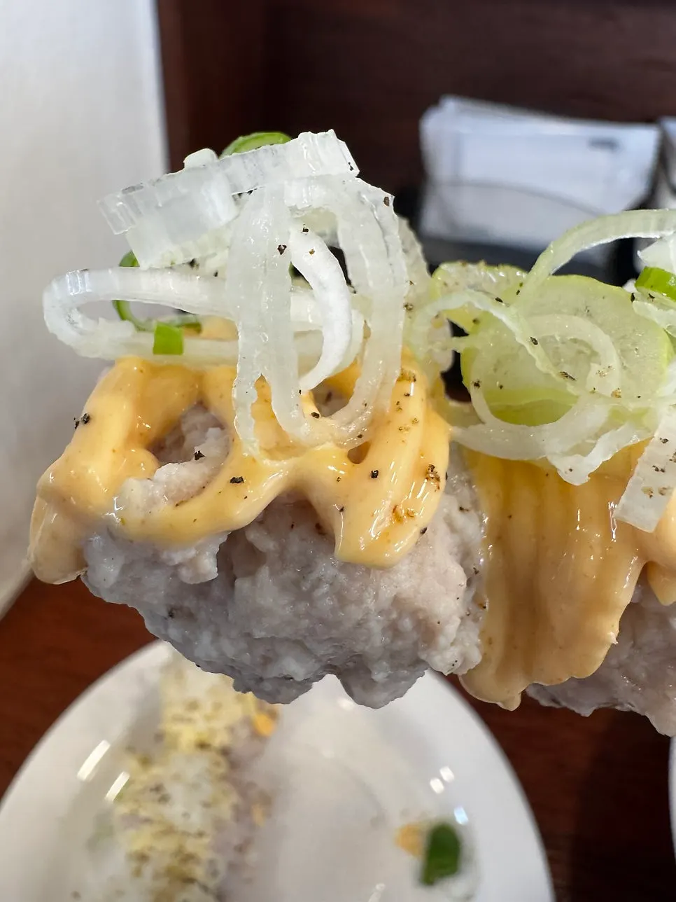Tsukune meatballs topped with a cheese-cream-like sauce