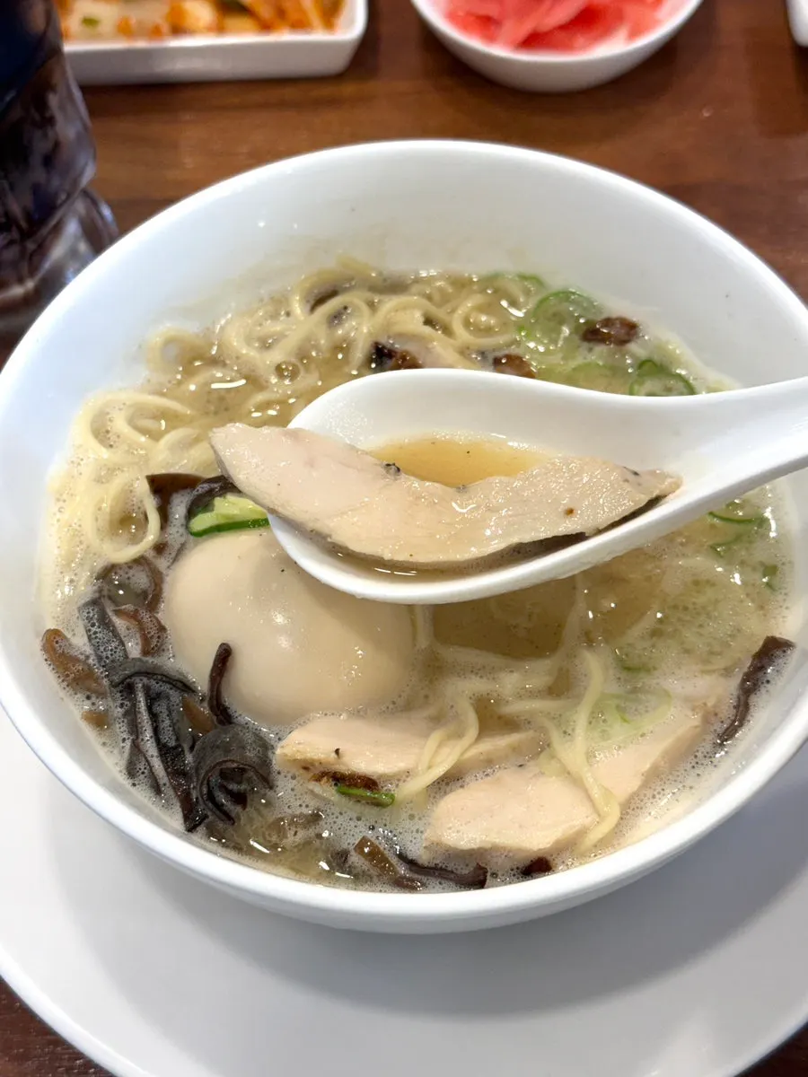 Noodles lifted from a bowl of tori paitan