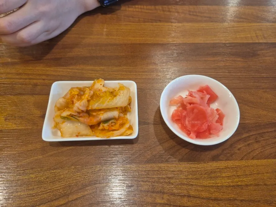 Bowl of kimchi and pickled ginger side dishes