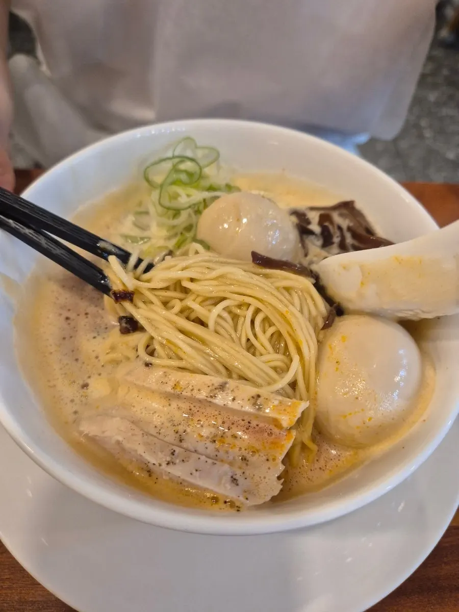 Karapaitan ramen topped with chicken breast and fried onion
