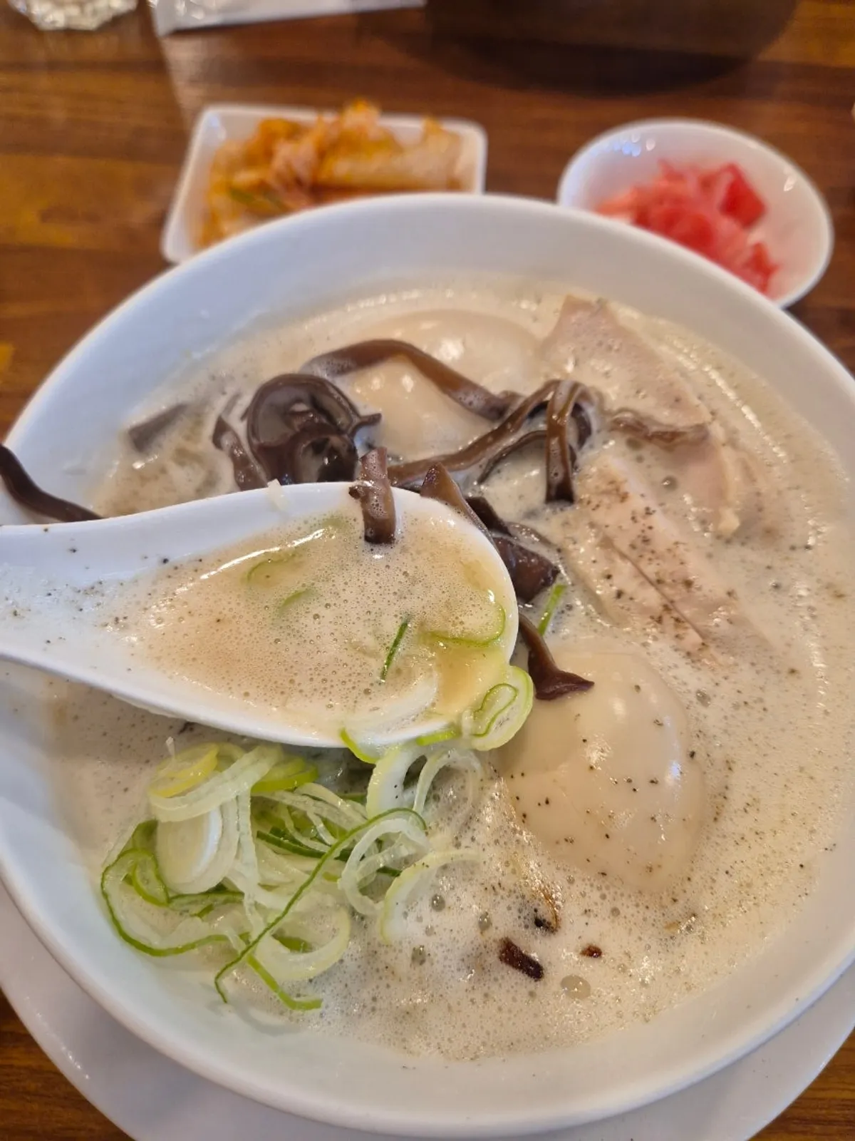 Tori paitan ramen topped with long strips of wood ear mushroom