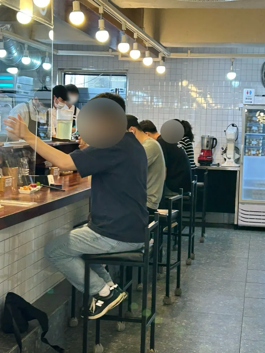 Solo-dining counter seats with a view of the open kitchen