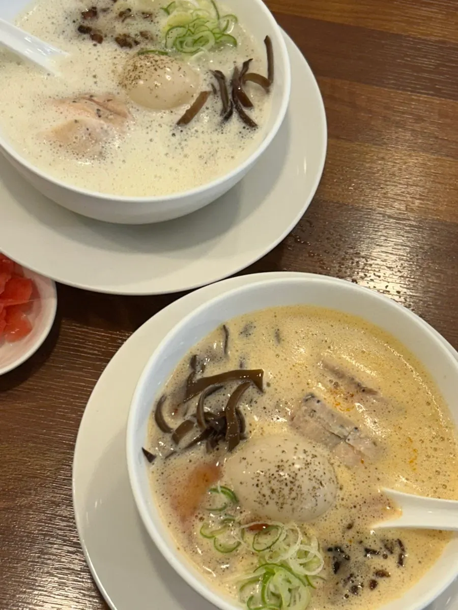 Two ramen bowls and assorted tsukune served together