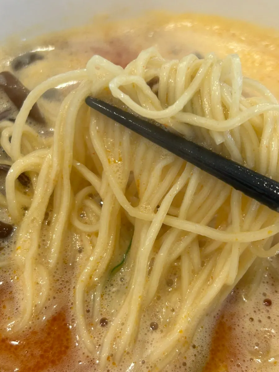 Lifting up the springy ramen noodles