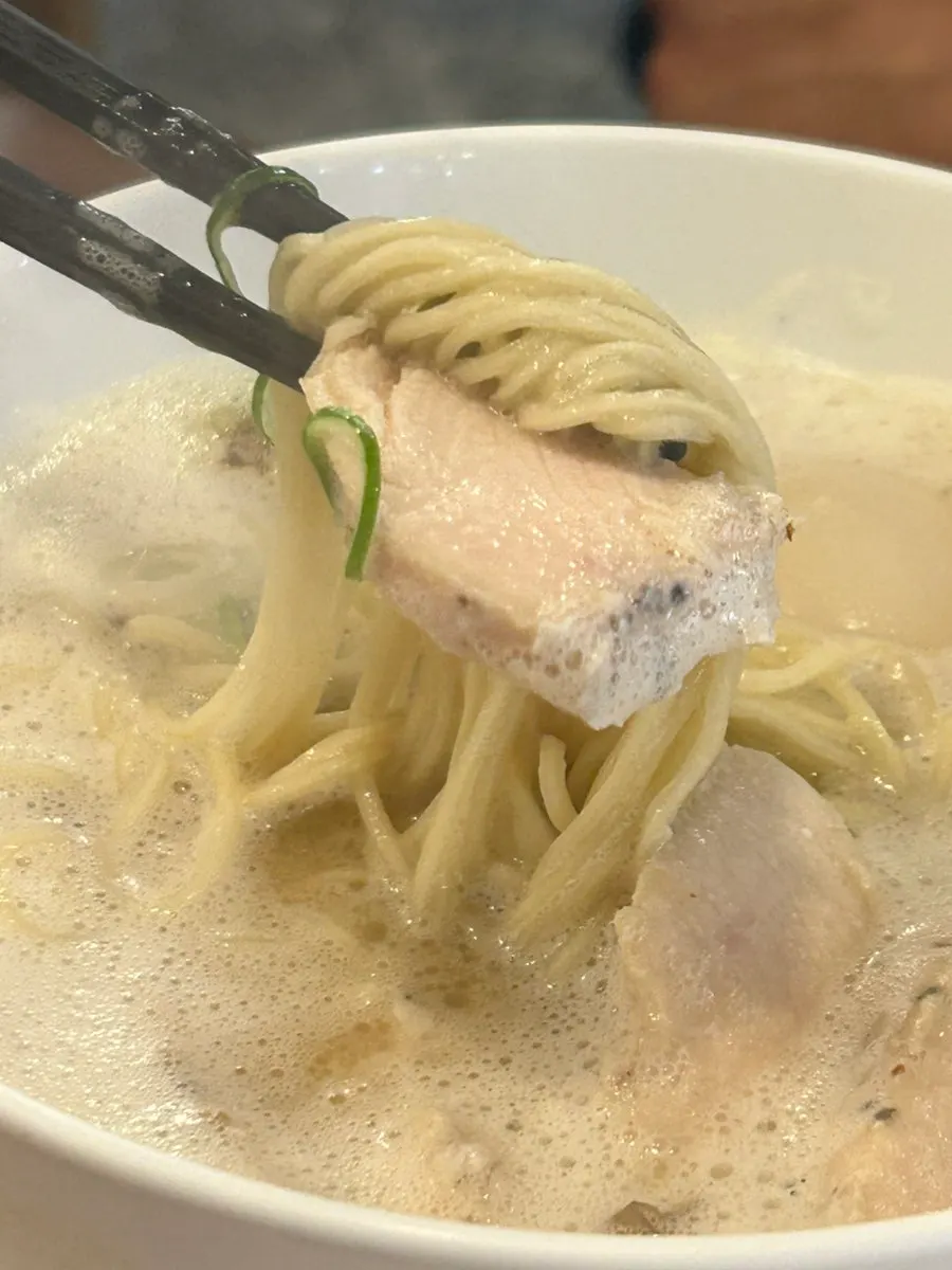 A spoonful of tori paitan broth and toppings together