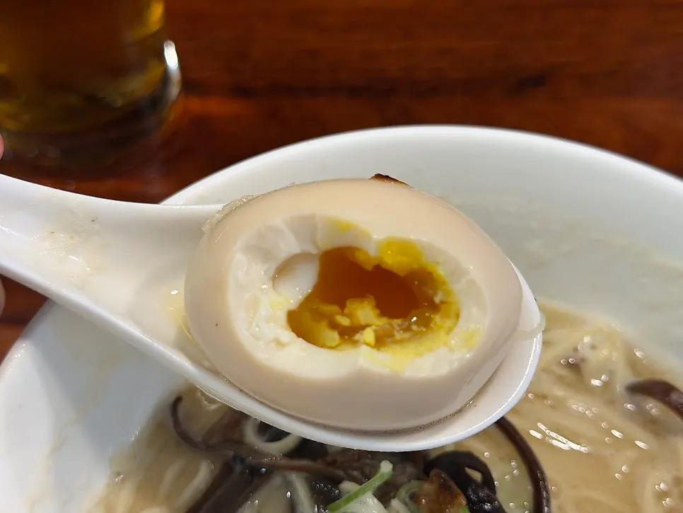 A whole soft-boiled egg on top of the ramen