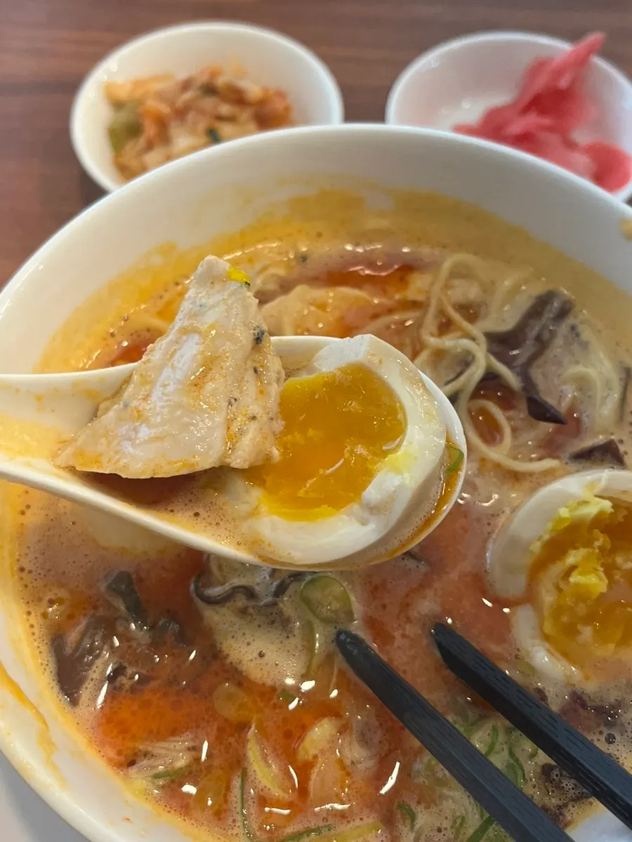 A bite combining soft egg and chicken