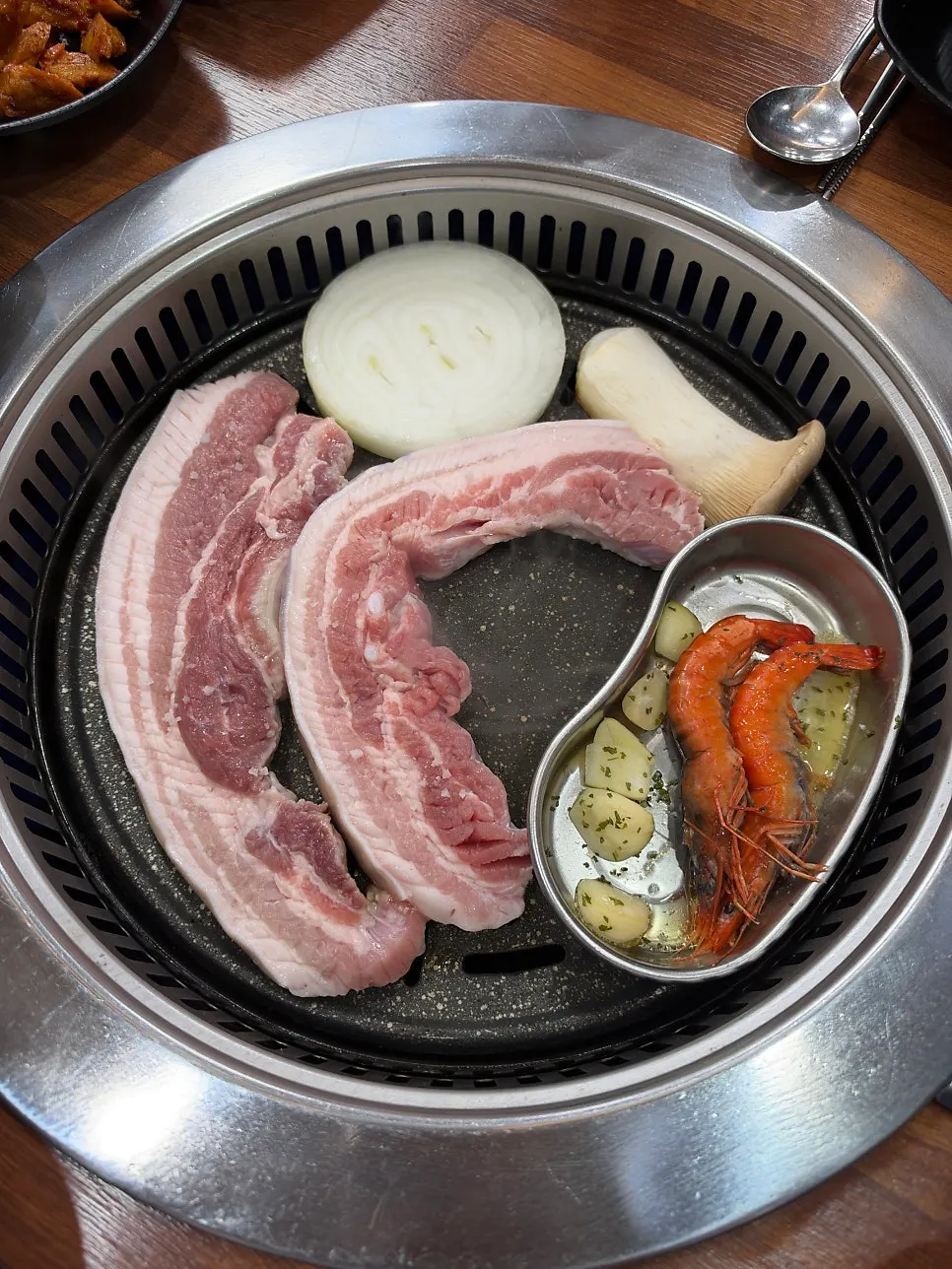Black pork belly cooking on the hot griddle
