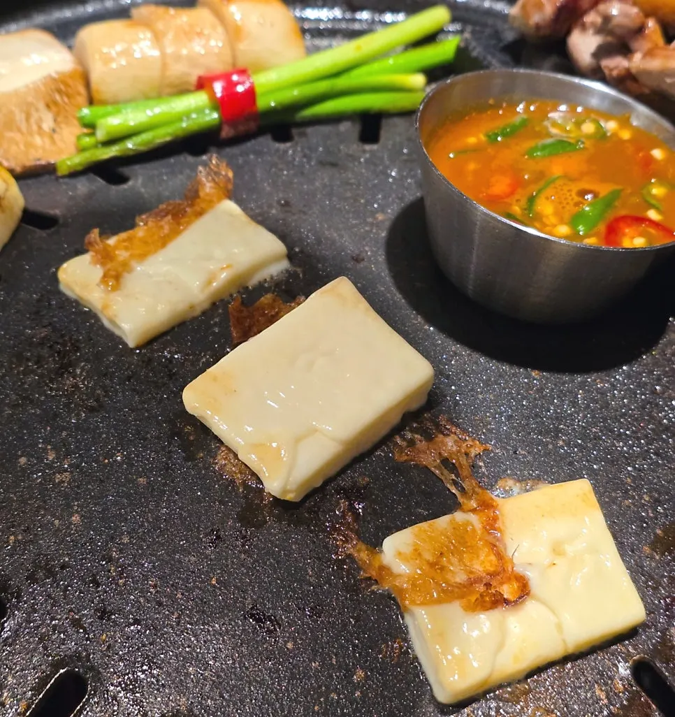 Meat wrap topped with grilled cheese