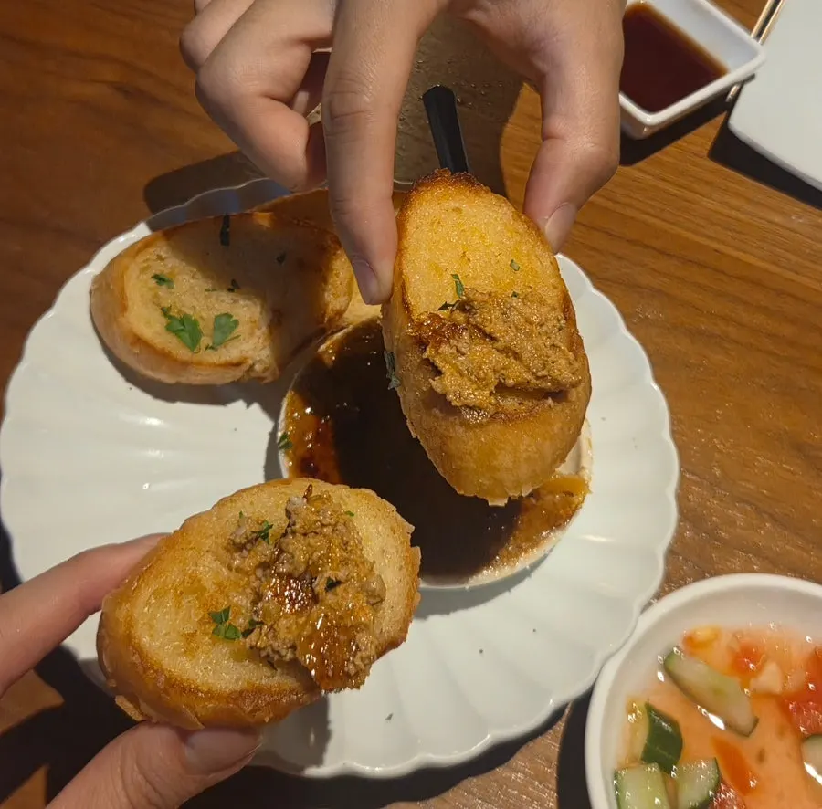 Ankimo piled onto a piece of baguette