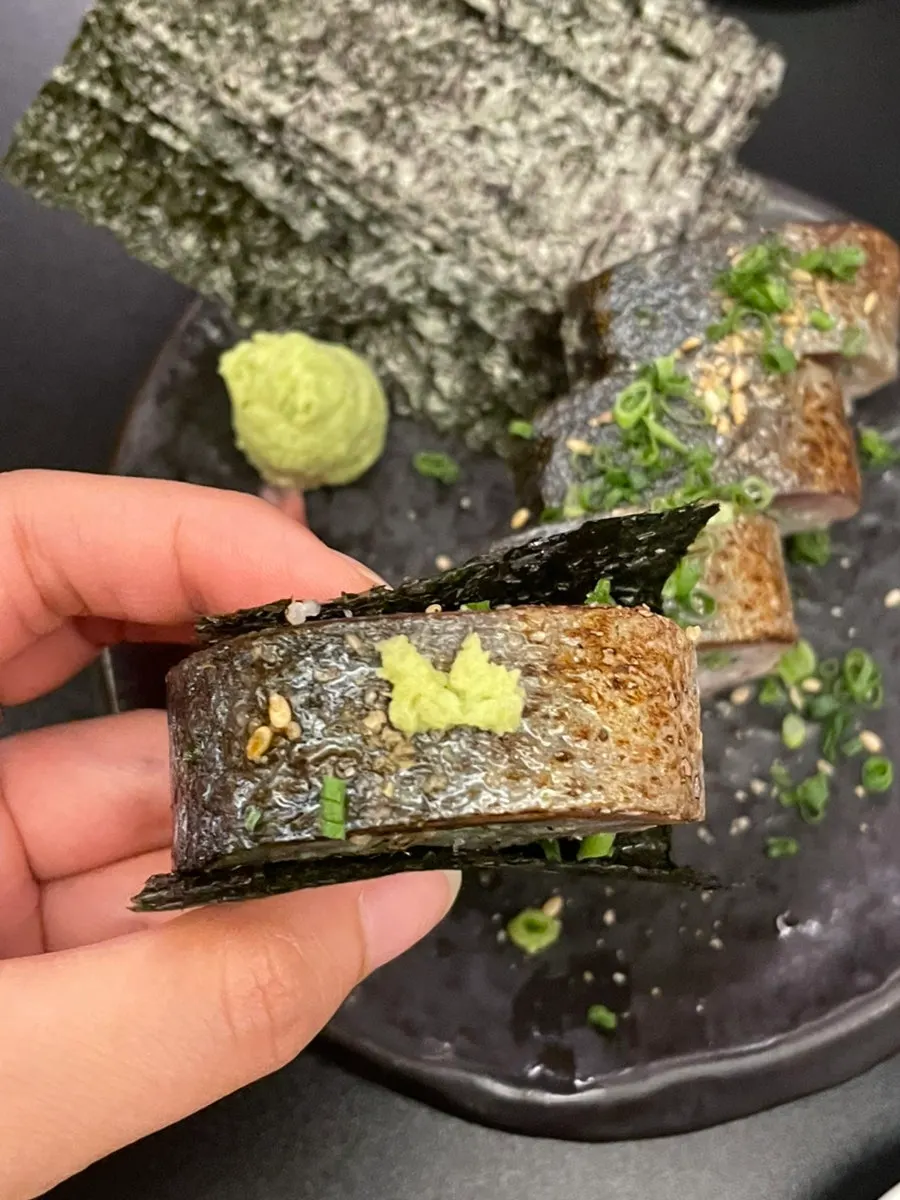 Close-up of a single piece of mackerel roll sushi