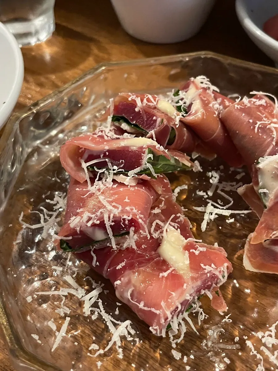Close-up of jamón maguro topped with truffle sauce and shiso leaf
